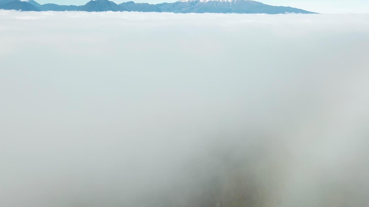 Flying Into Clouds Above Jungle and Volcanic Hills. Drone Aerial View