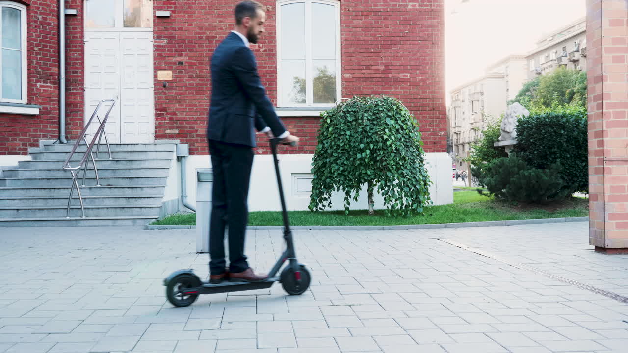 Man Riding Electric Scooter in Urban Environment