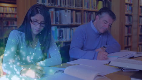 animation of light spots over diverse man and woman writing