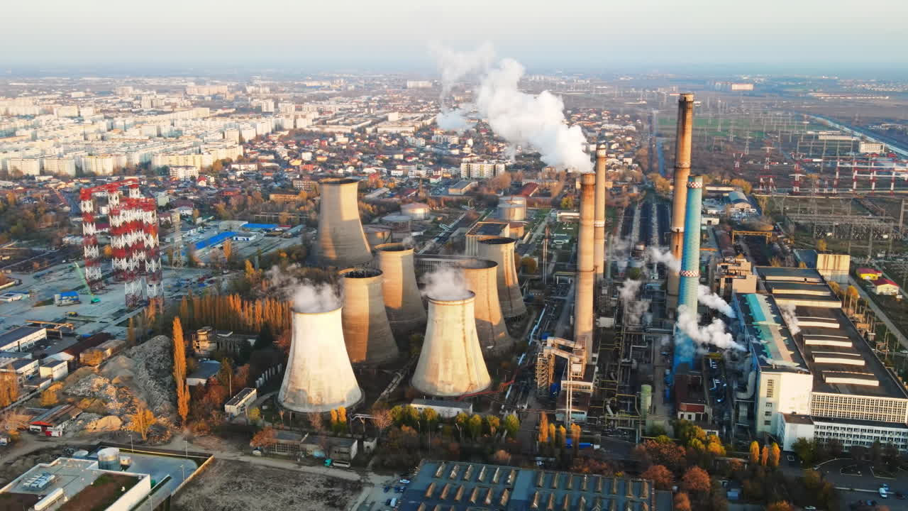 Power station with a lot of tubes and facilities in Bucharest at sunset, a lot of foam. Cityscape, view from the drone, Romania