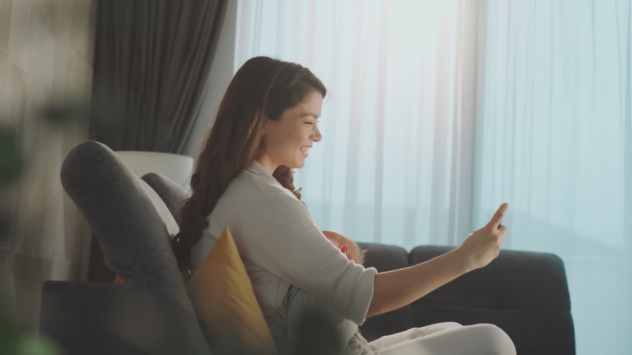 Mother taking video call with baby