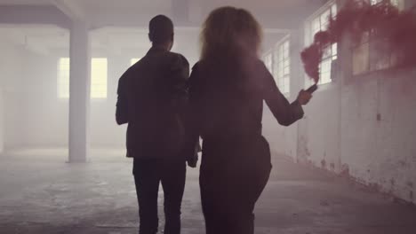 Fashionable-young-man-and-woman-in-an-abandoned-warehouse