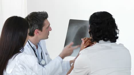 Doctor-explaining-an-xray-to-a-patient-in-office