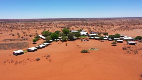 A-long-drone-shot-around-a-lodge-in-Namibia-with-small-houses-and-a-pool