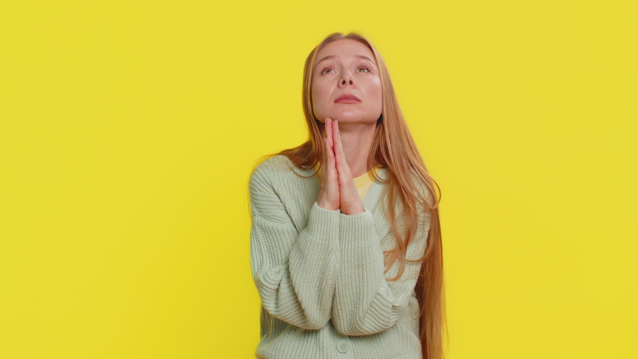 Middleaged woman praying making wish asking hopeful help begging apology meditation imploring