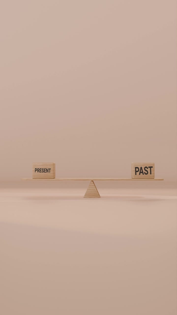 VERITCAL VIDEO OF PRESENT AND PAST BALANCING ON SEESAW