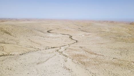 Flying-over-the-desolate-ground-at-base-of-the-Ramon-Crater