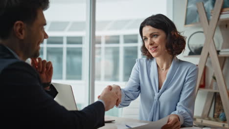 Woman manager concluding agreement with man partner at conference room closeup