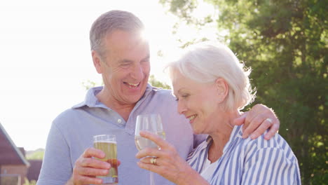 portrait of senior couple enjoying outdoor summer drink at pub