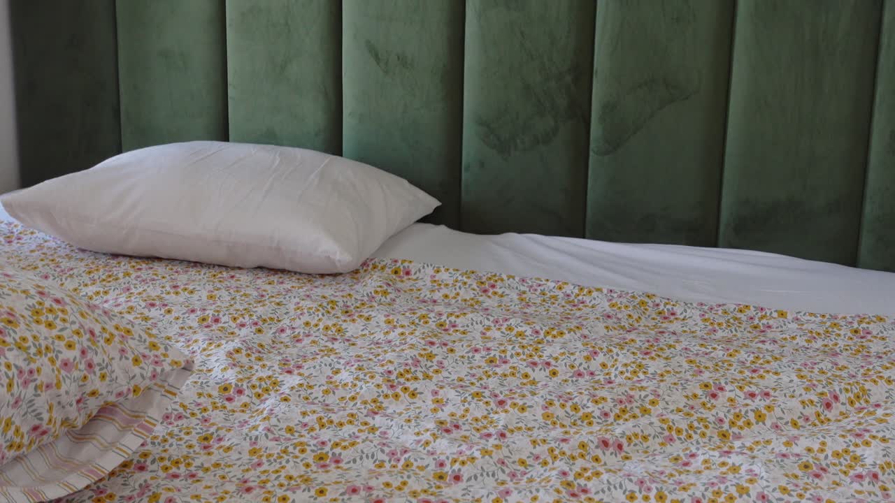 Bedroom with Floral Bedding and Green Wall
