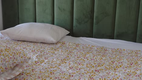 bedroom with floral bedding and green wall