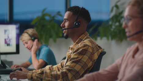business team wearing headsets working late at customer support centre