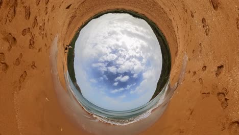 playa de arena con arena roja y cielo azul claro en la isla de gozo, malta - una impresionante vista del planeta invertido 360