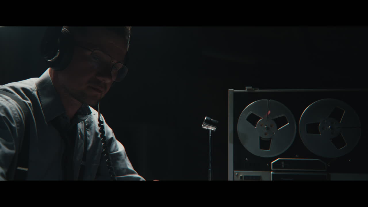 An intelligence officer listens to the wiretap recordings