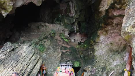 tourists explore a colorful cave shrine