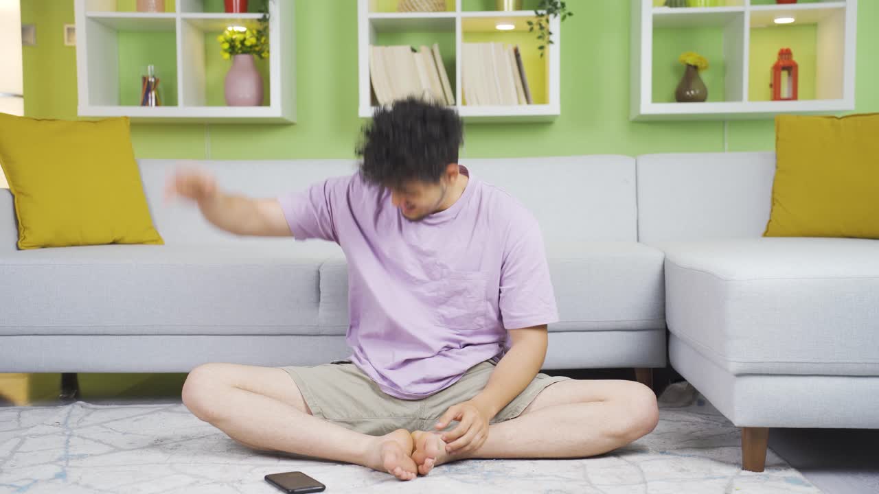 Seeing his failure on the phone, the young man is frustrated.