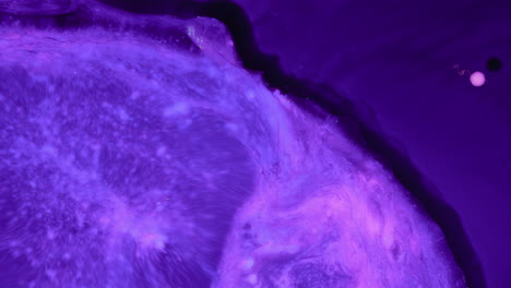 abstract white fluid mixing and expanding into purple mix