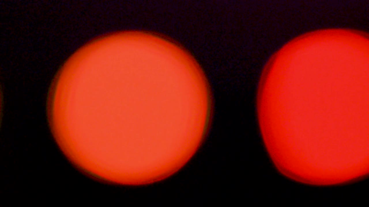 Orange and red blurring lights abstract circular bokeh on black background video