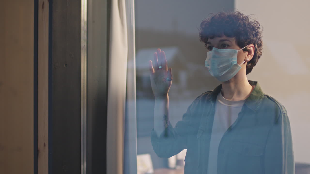 Sad Woman In Protective Mask Standing Near Window