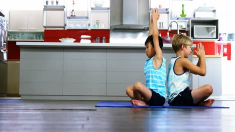 Siblings-practicing-yoga-in-kitchen