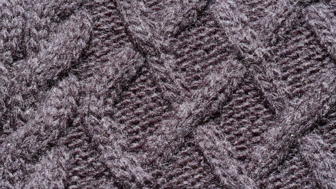 Close-up view of dark gray cable knit fabric