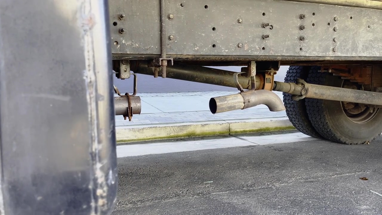 Underside Of A Heavy Truck Showing The Exhaust Pipe Assembly And Chassis Frame. Sideways Shot