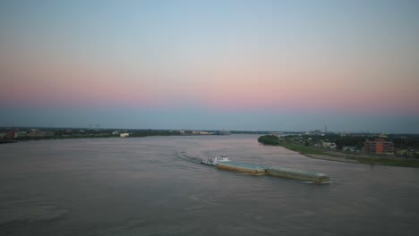 barge and push boat working hard along the mighty mississippi river in new orleans