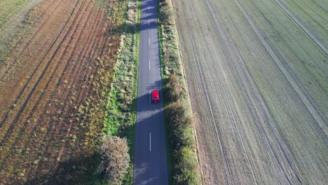 Red-car-on-road-is-overtaken