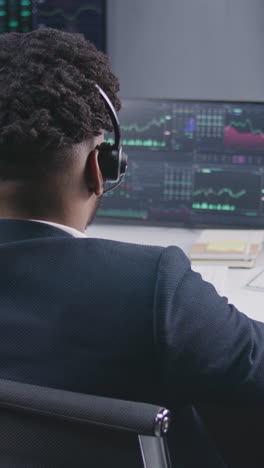 multi ethnic team of traders work on multi-monitor computers with displayed real-time stocks. colleagues analyze exchange market charts on big screens. cryptocurrency trading and investment concept.