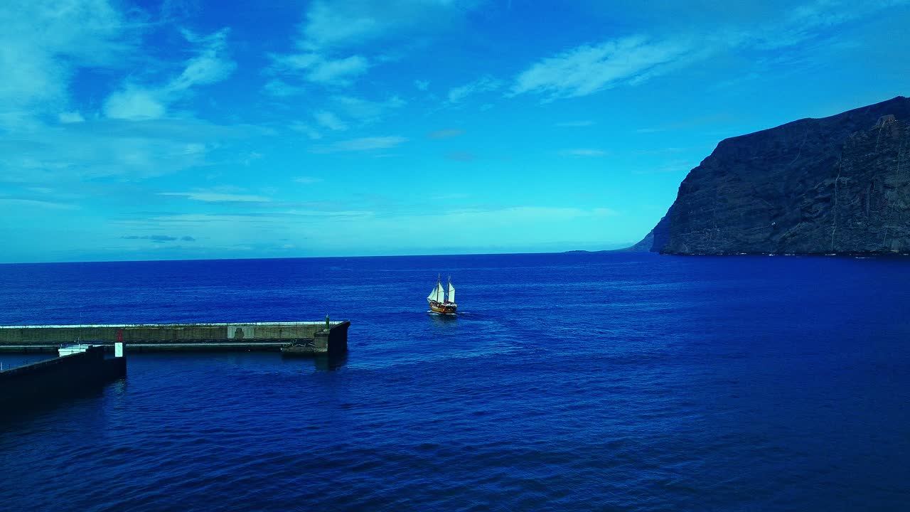 impresionante disparo que revela el barco que navega desde el puerto deportivo hasta el océano azul abierto, tenerife, españa