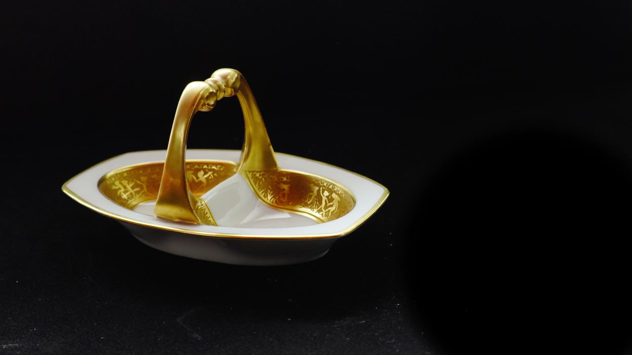 Gloved hands present gold plated tableware against a black background, evoking exclusivity, prestige, and high-end hospitality. Ideal for luxury branding, fine dining, and premium lifestyle storytelli