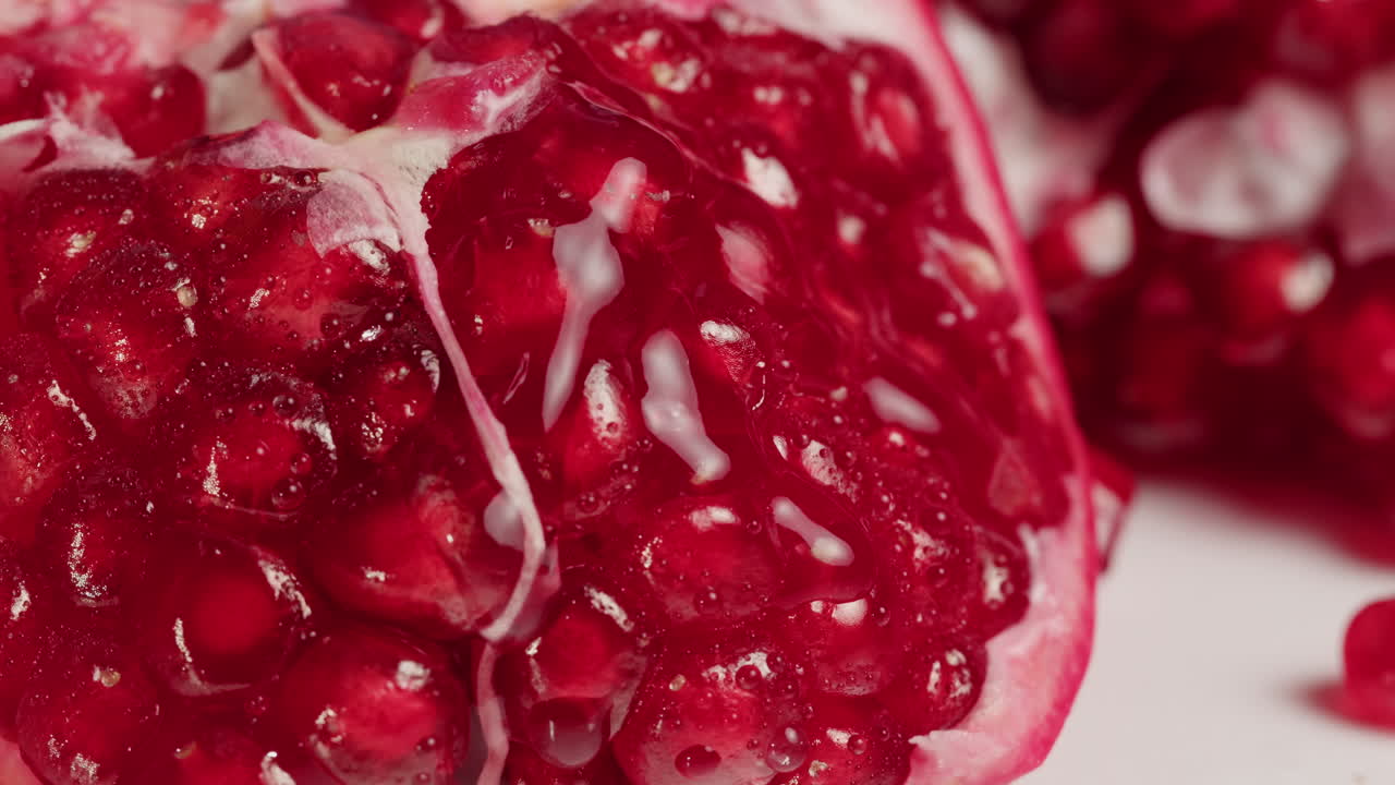 Close-up of Fresh Pomegranate Seeds with Dripping Juice