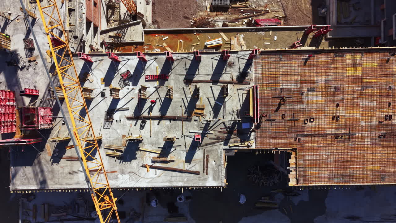 Construction site shows workers and machinery during a building project in a city environment on a clear day
