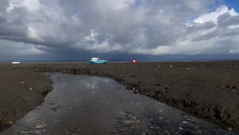 morecambe bay blue boat and angry clouds