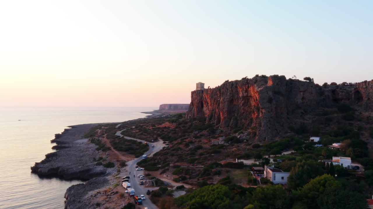 Aerial view of Sicily coastline at sunset, highlighting cliffs and beach