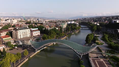 beautiful cinematic drone shot above kura river in downtown tbilisi, georgia