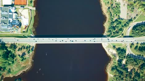 Aerial-overhead-time-lapse-shot-over-a-bridge-with-many-cars-driving-on-it