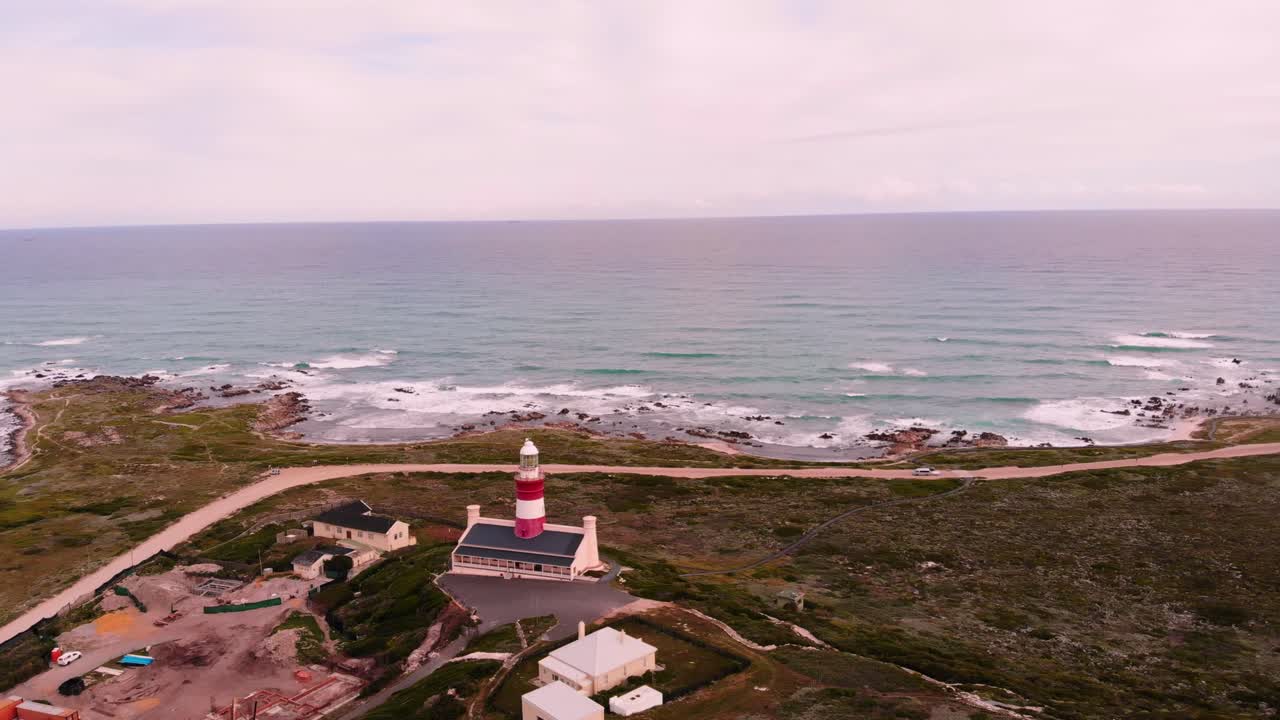 Wide drone shot orbits around the establishments, close to the beach side of the area.