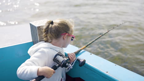 little girl fishing from a boat