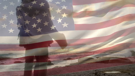 animación de la bandera de los estados unidos sobre una pareja afroamericana en la playa