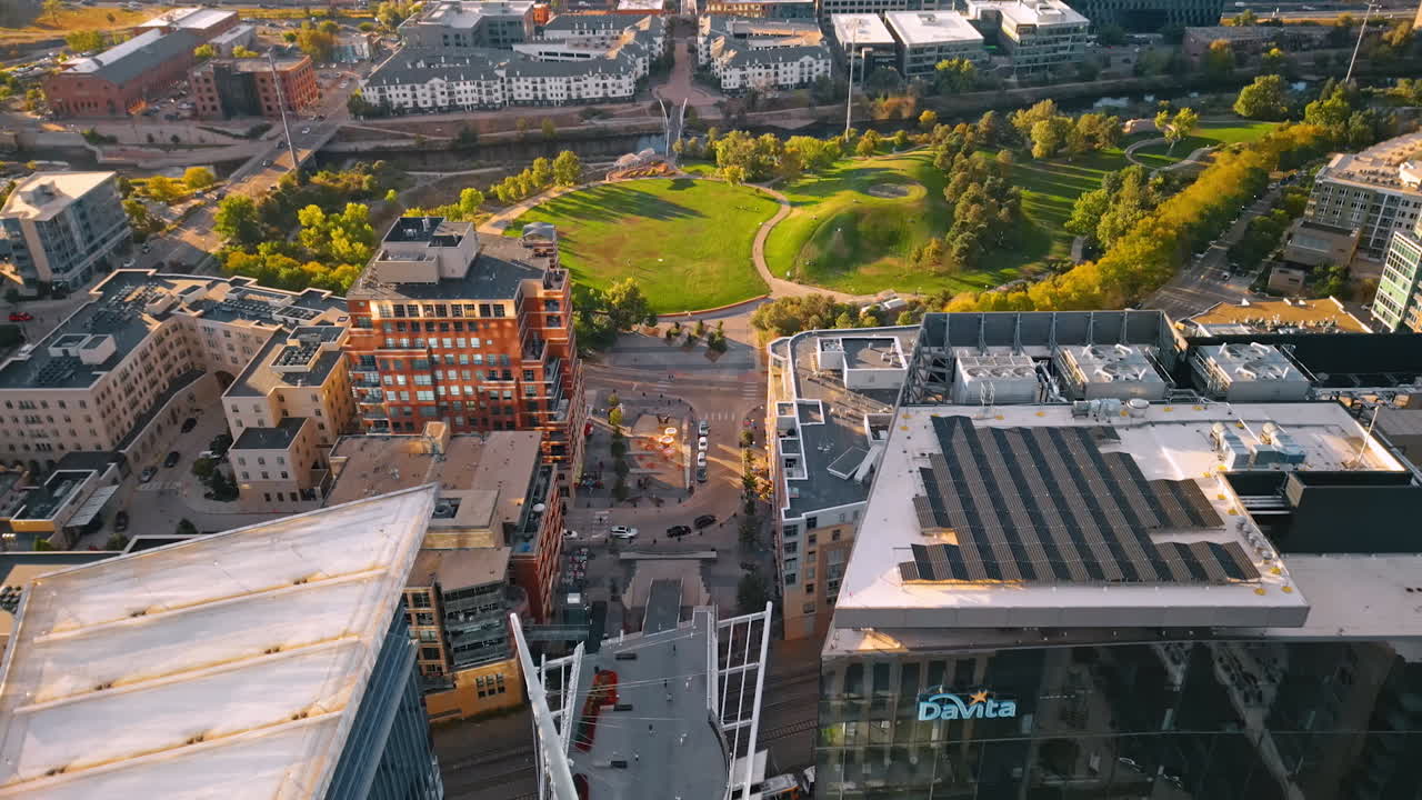 Denver, USA, 28 July 2025: Flight over diverse high-rise buildings in the downtown of Denver, Colorado, USA. Approaching beautiful green park in the cityscape