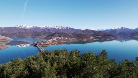 Long-bridge-over-huge,-crystal-clear-blue-lake