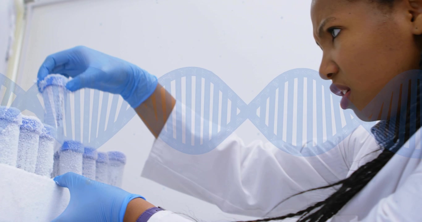 After rack removal from freezer tech lifting frozen vial inspecting under DNA helix for testing