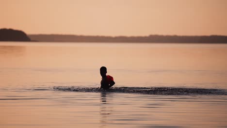 children playing in water. little cute boy swimming and splashing with water in the river during vacation