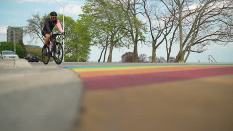 cars drive over a rainbow cross-walk in slowmotion. ontario.