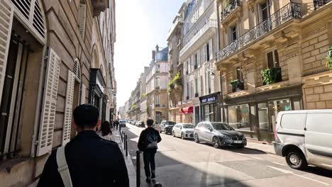 people walking on a sunny paris street