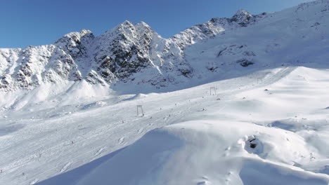 Aerial-view-of-snowy-piste-during-Beautiful-sunny-day-ski-field-glacier-at-Kauntertal,-Austrtia