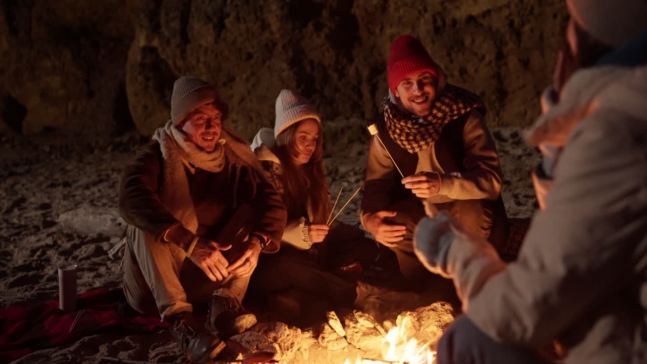 Friends Enjoying a Campfire at Night on the Beach