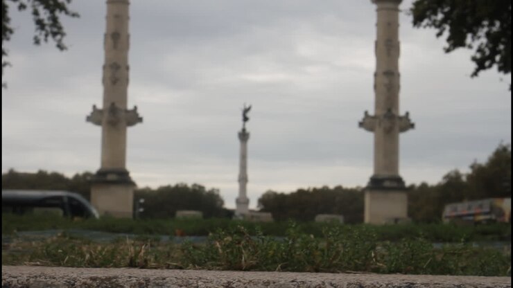 View of a city with a statue and a tram