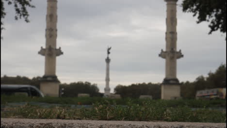 view of a city with a statue and a tram